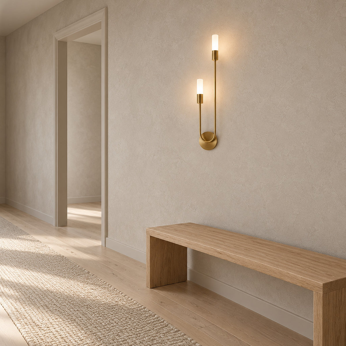 Amolven gold hardwired wall sconce lit on an uninterrupted hallway wall in daylight