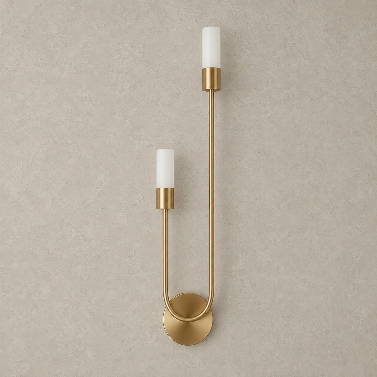 Amolven gold hardwired wall sconce unlit, two light heads set at staggered heights on a plain backdrop