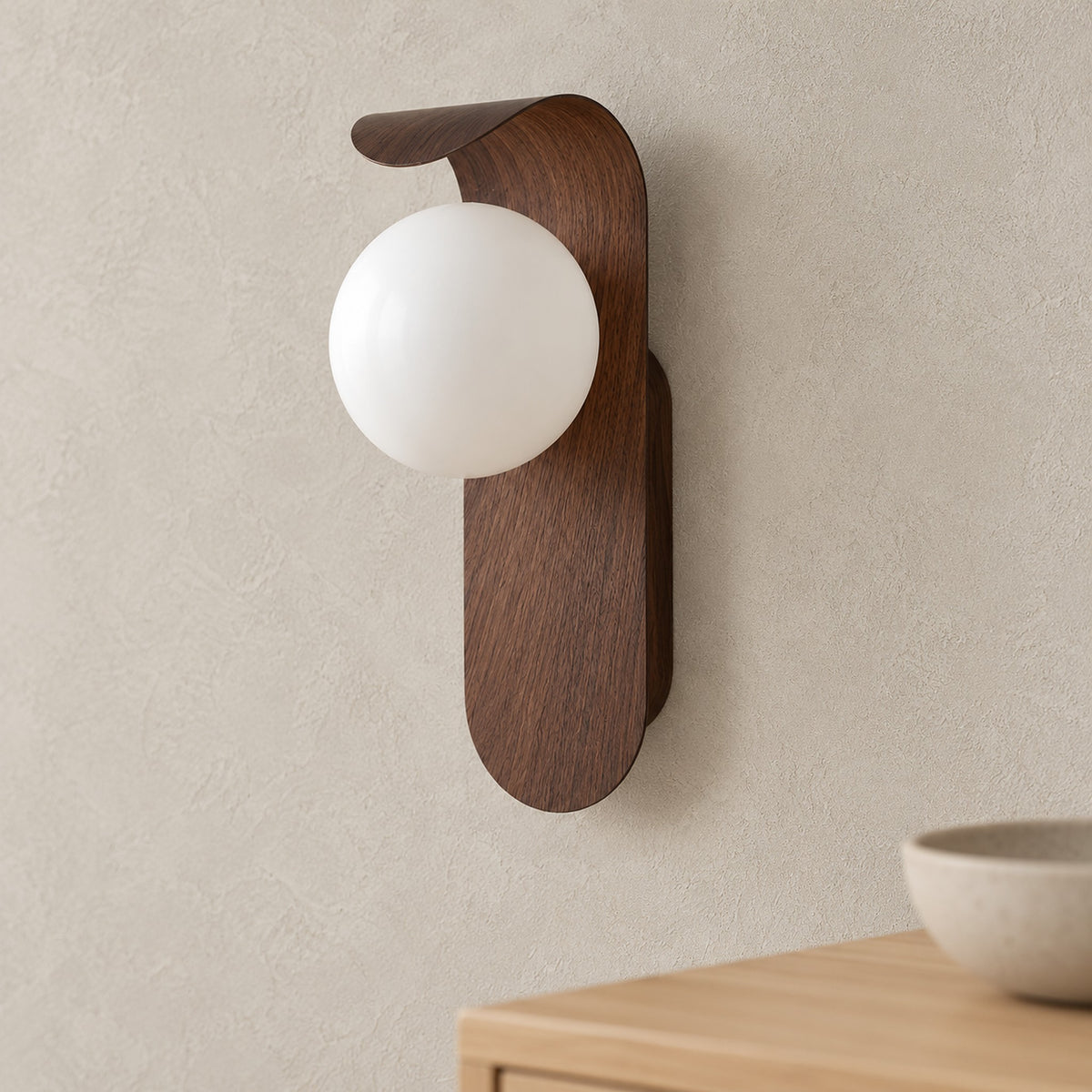 Arcelmo walnut wall sconce close up of the globe and curved wood grain accent on its iron body
