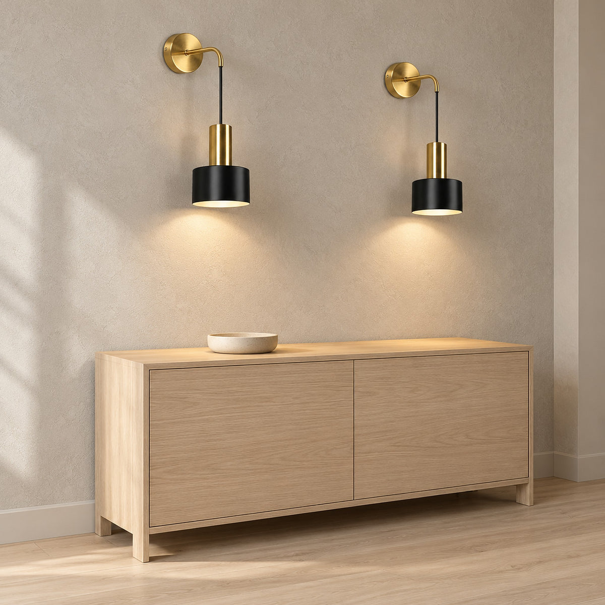 Arsomel black and gold rechargeable wall sconce pair lit above an entryway console
