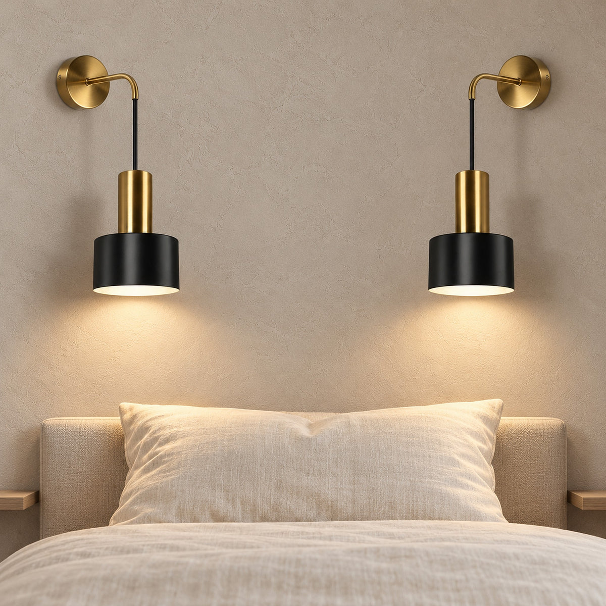 Arsomel black and gold wall lamp pair glowing beside a daybed in a bright alcove