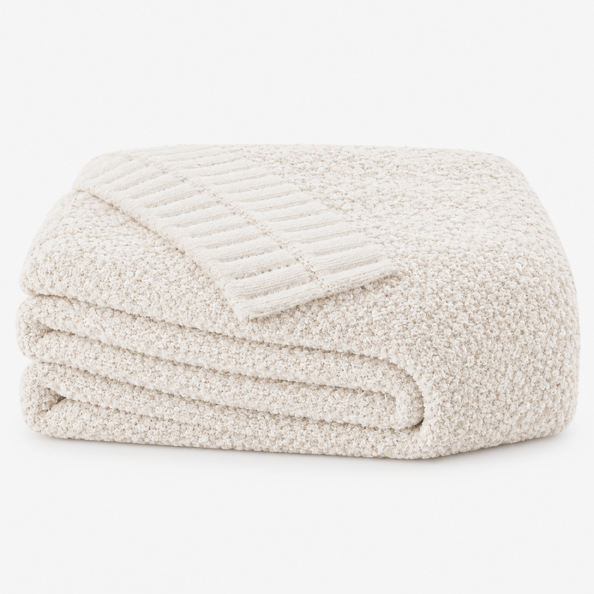 Calemira reversible throw blanket in ivory, loosely folded on a white background