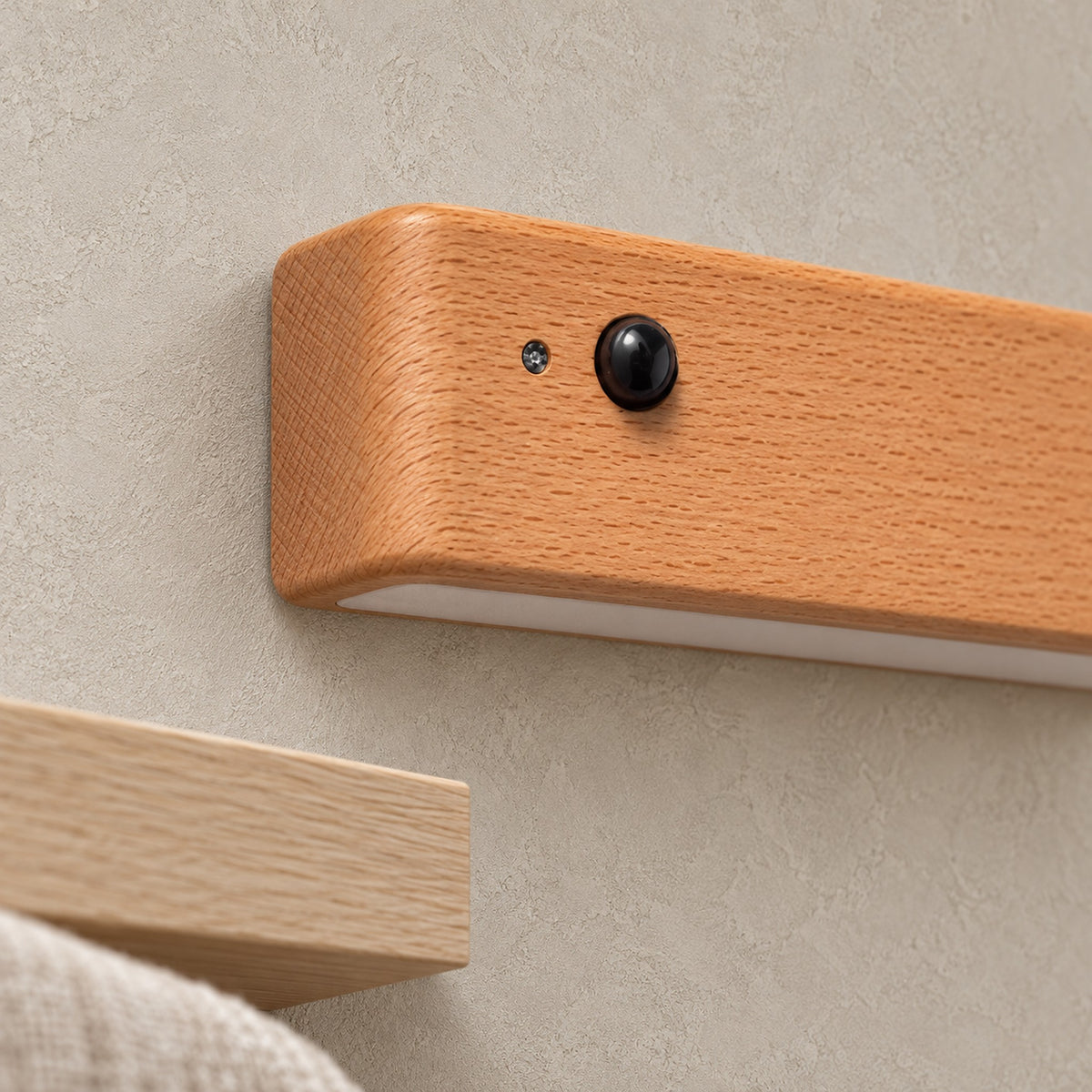 Calenvi natural motion sensor night light, close up of the cordless wall lamp body and lower diffuser