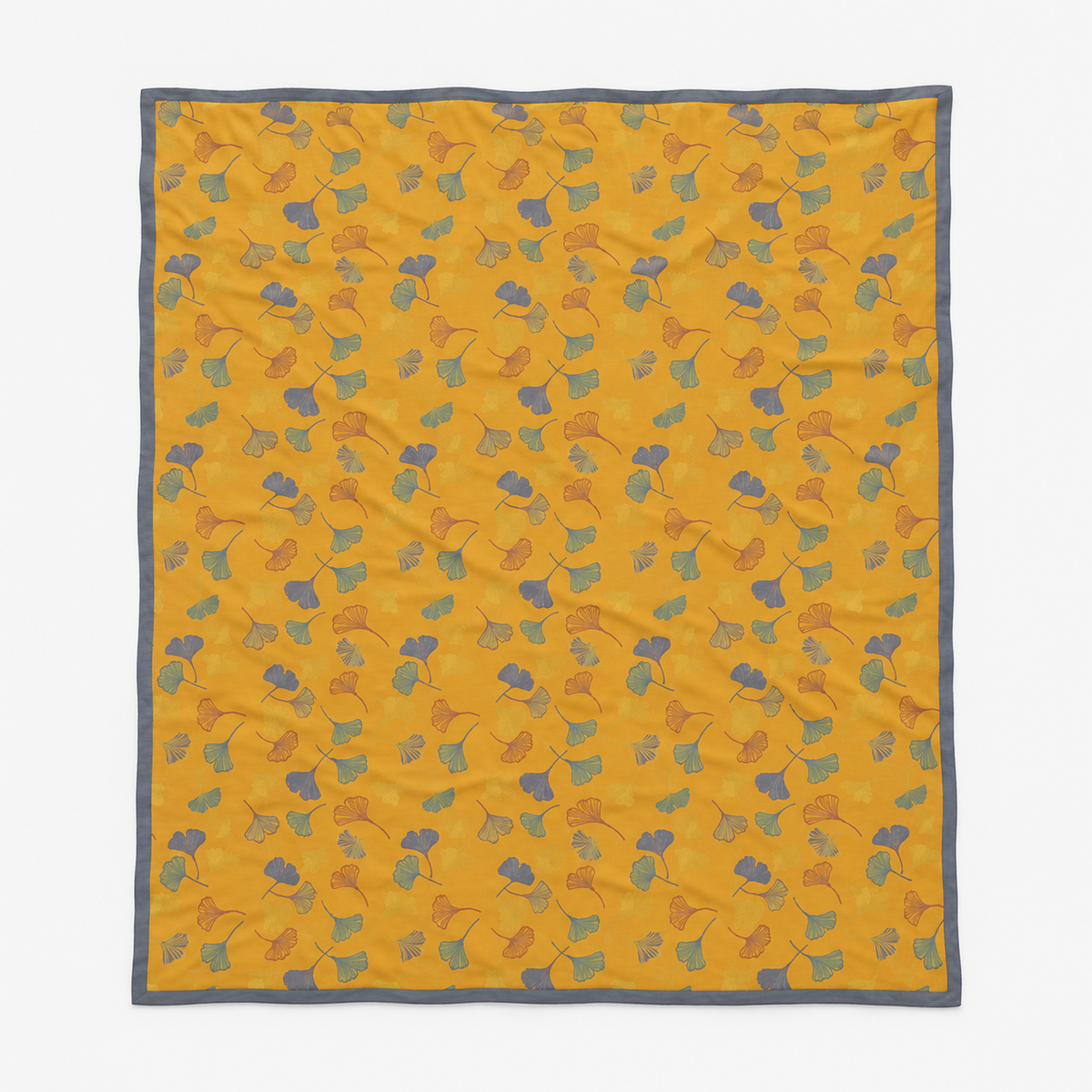 Calimor ginkgo leaf throw blanket in mustard yellow and gray laid fully open flat to show the whole rectangular shape