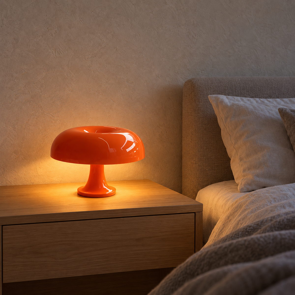 Camolire orange cordless table lamp lit on a bedroom nightstand beside the bed