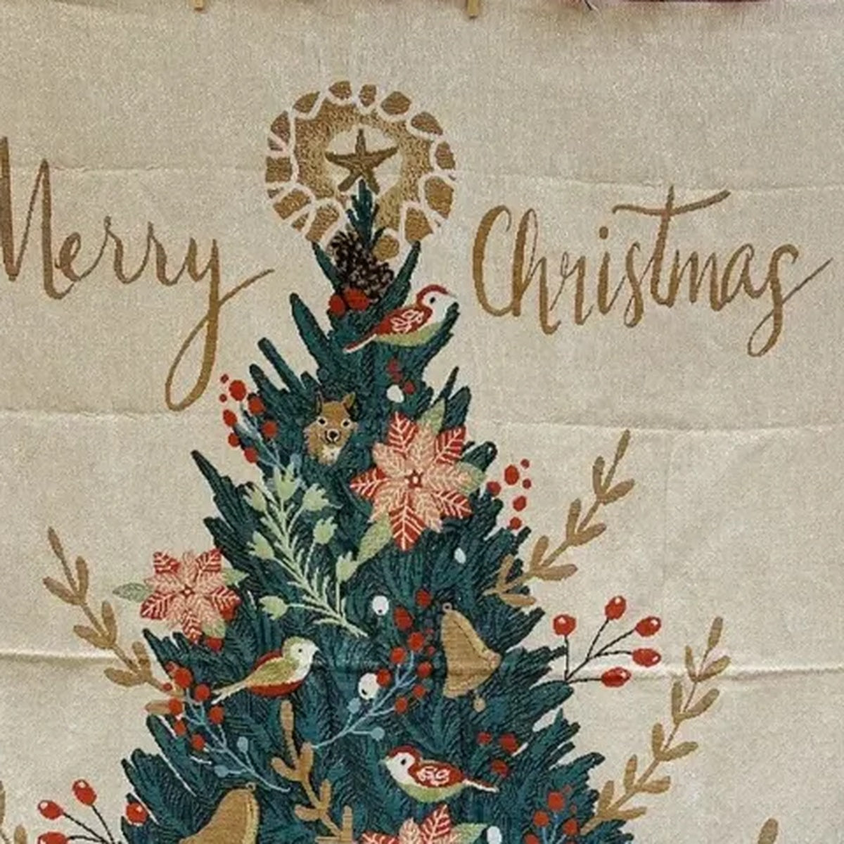 Close up of Canelvi christmas jacquard throw blanket showing a decorated tree and Merry Christmas lettering.