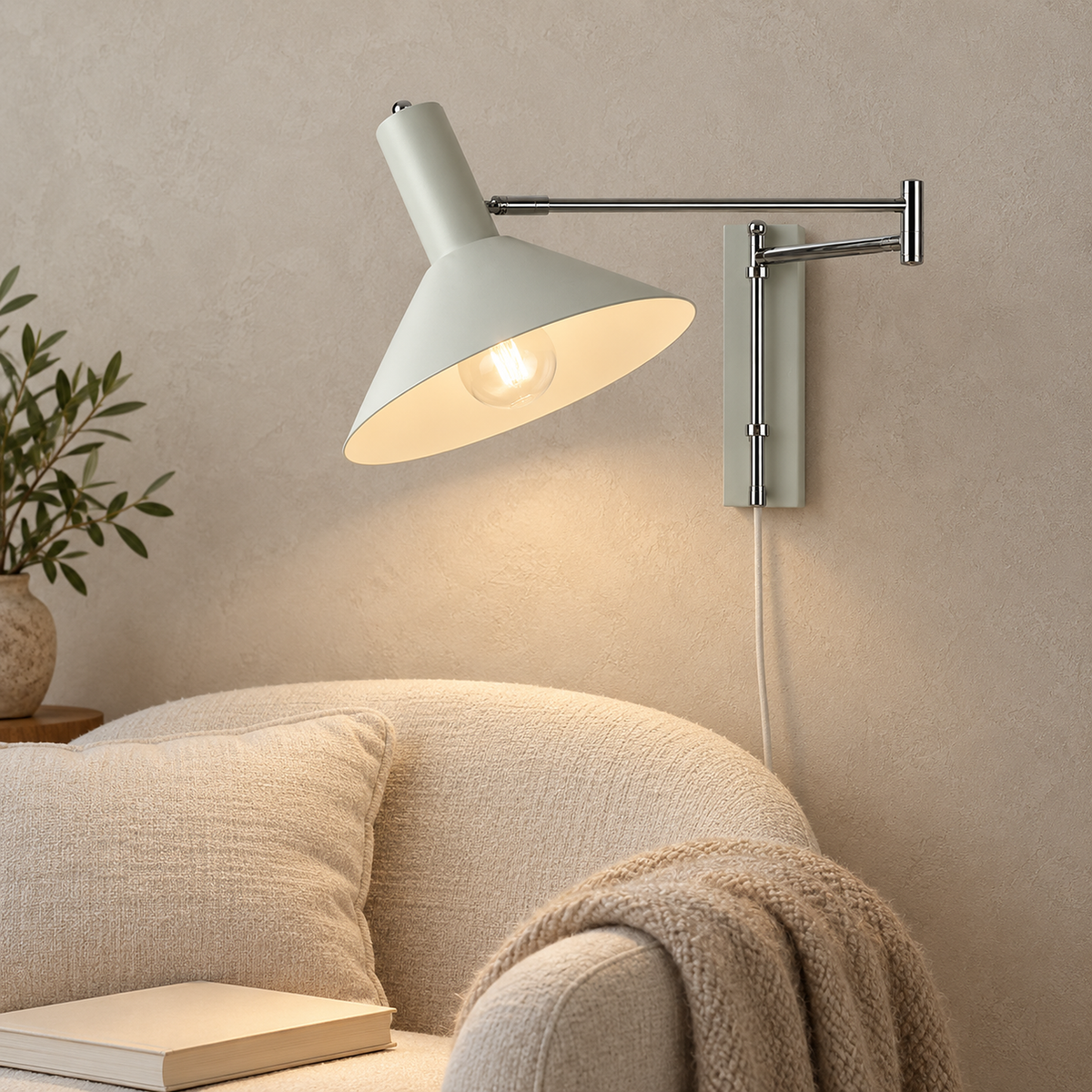 Celmoira white wall lamp lighting an ivory reading chair in a daylit library corner