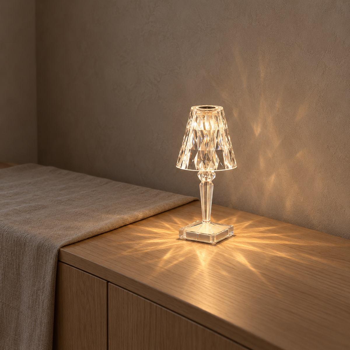 Cerilan clear table lamp seen from above its patterned tabletop while lit