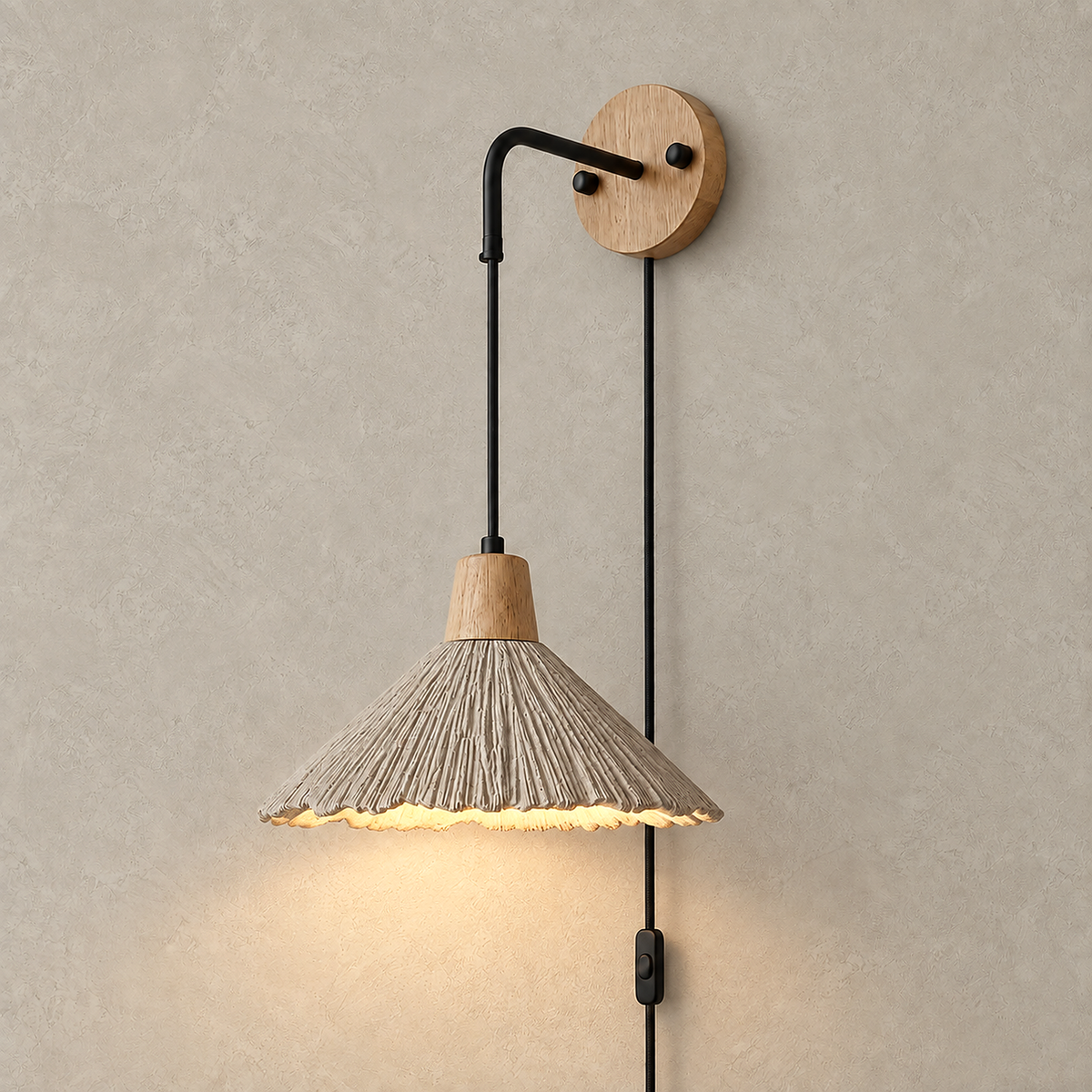 Cimessa wood color and cement gray bedside wall light with broad shade glowing against a plaster wall