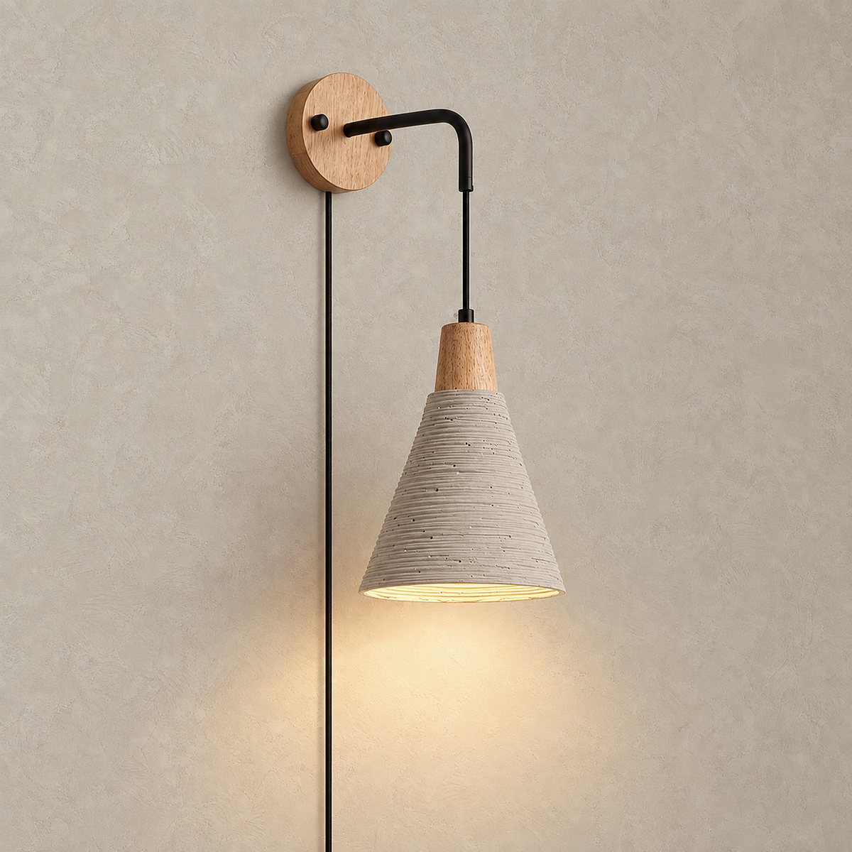 Cimessa wood color and cement gray plug in wall sconce model B lit alone on a plain plate