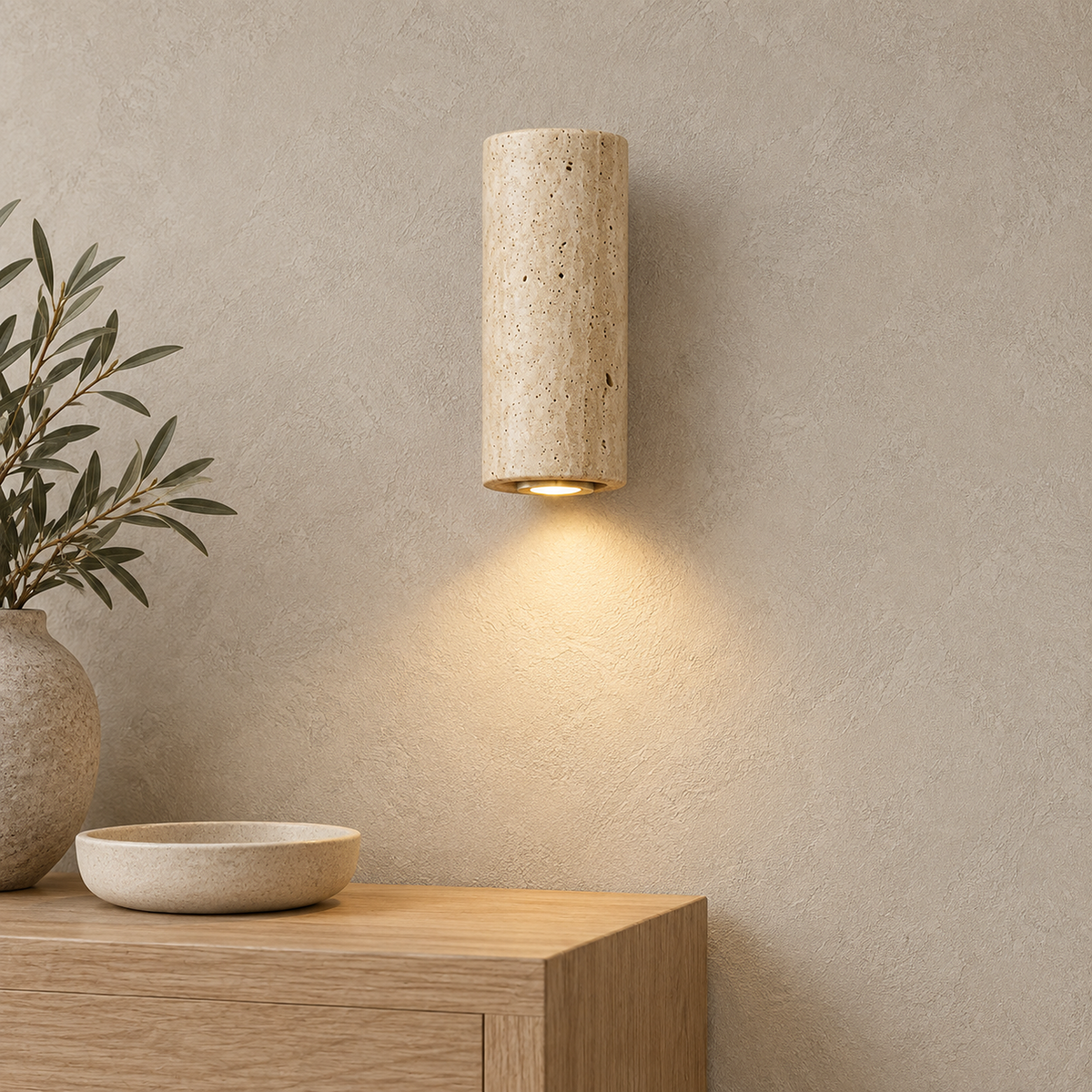Cimorela travertine wall lamp glowing warm above an entryway console table