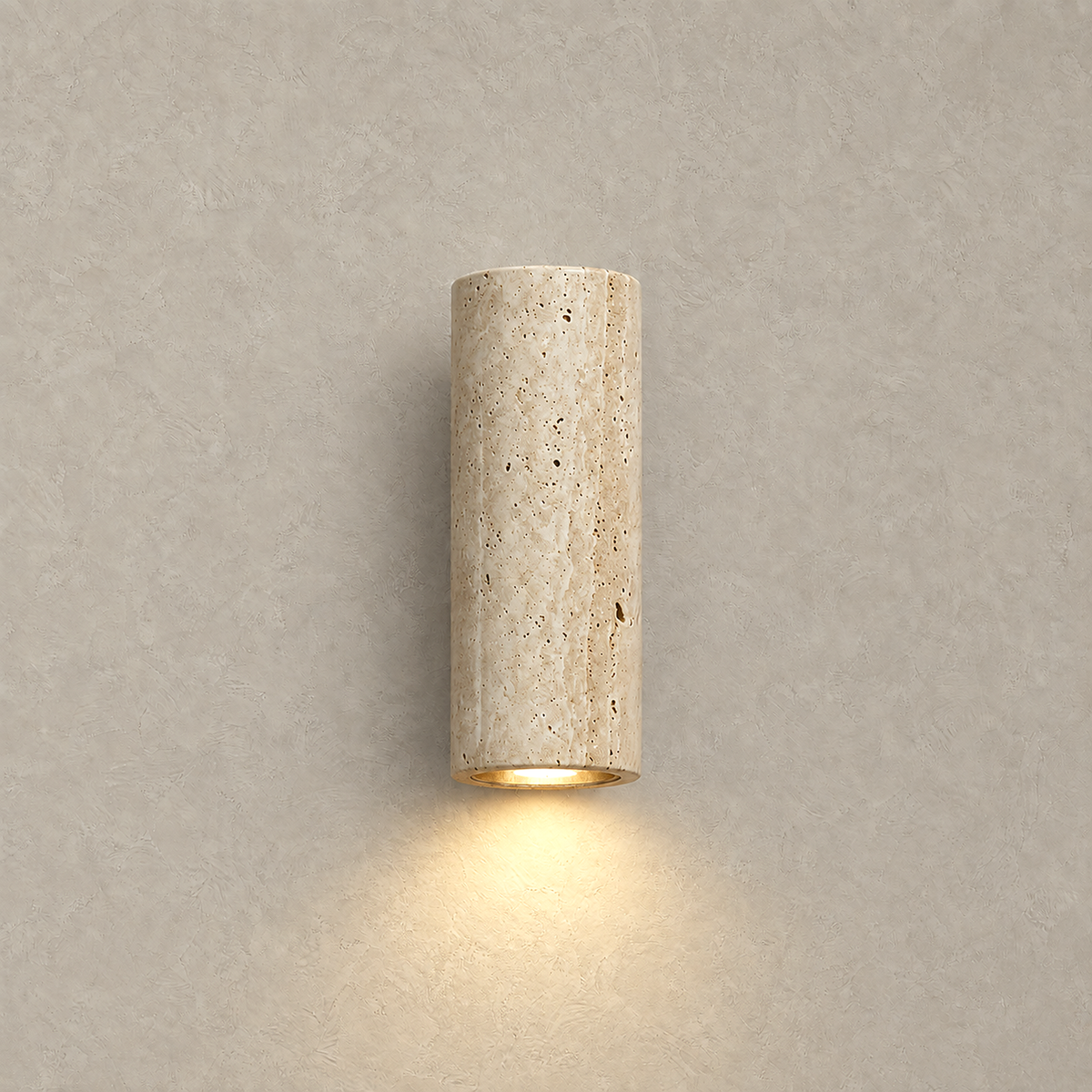 Cimorela travertine wall sconce lit with its warm glow washing down the wall