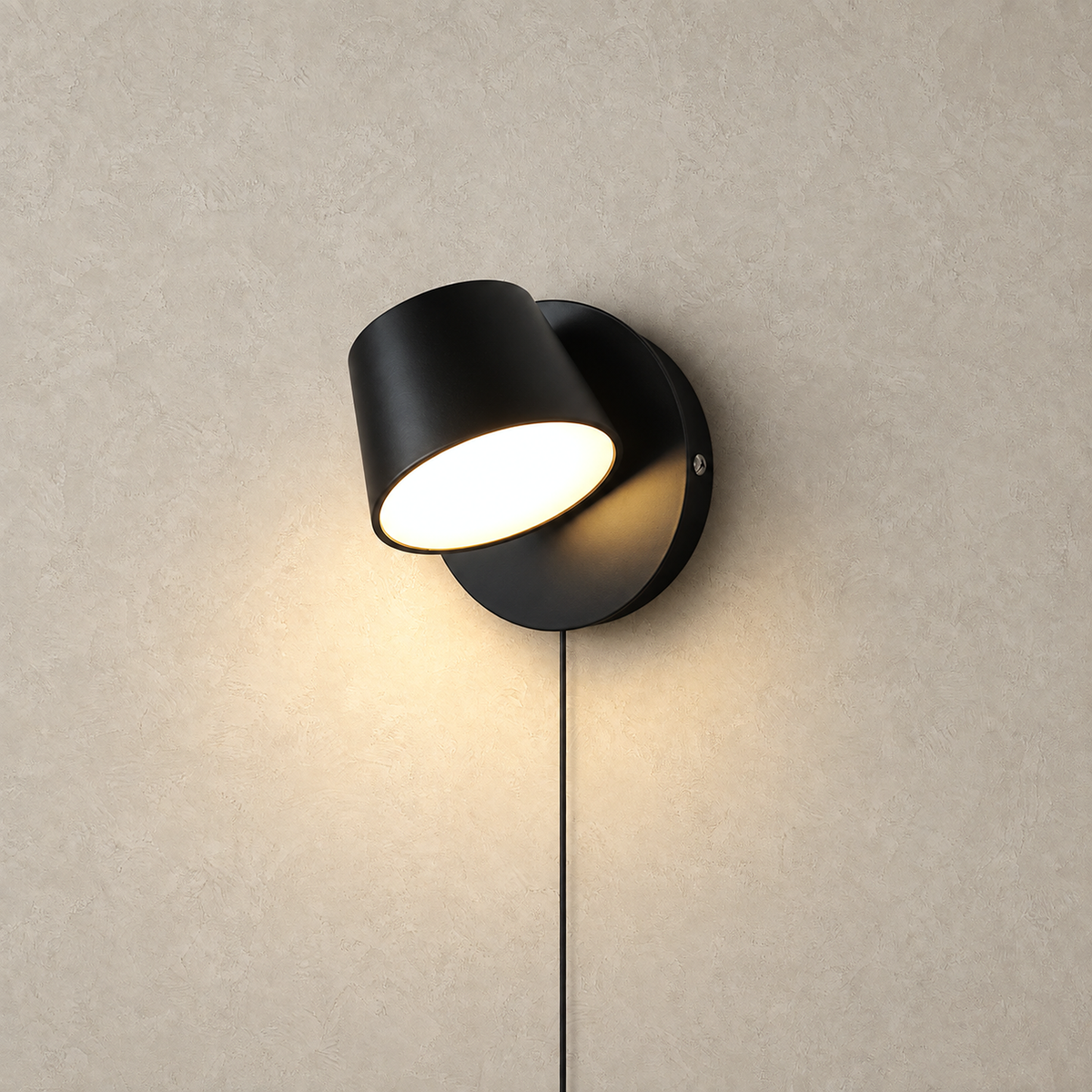 Cirelvo black single head LED reading wall sconce switched on alone on a plain studio plate