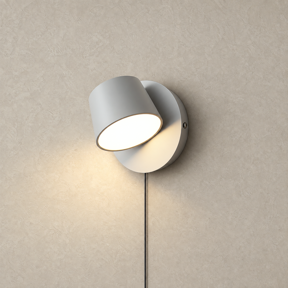 Cirelvo white single head LED wall sconce lit and glowing on a plain studio plate #color_white
