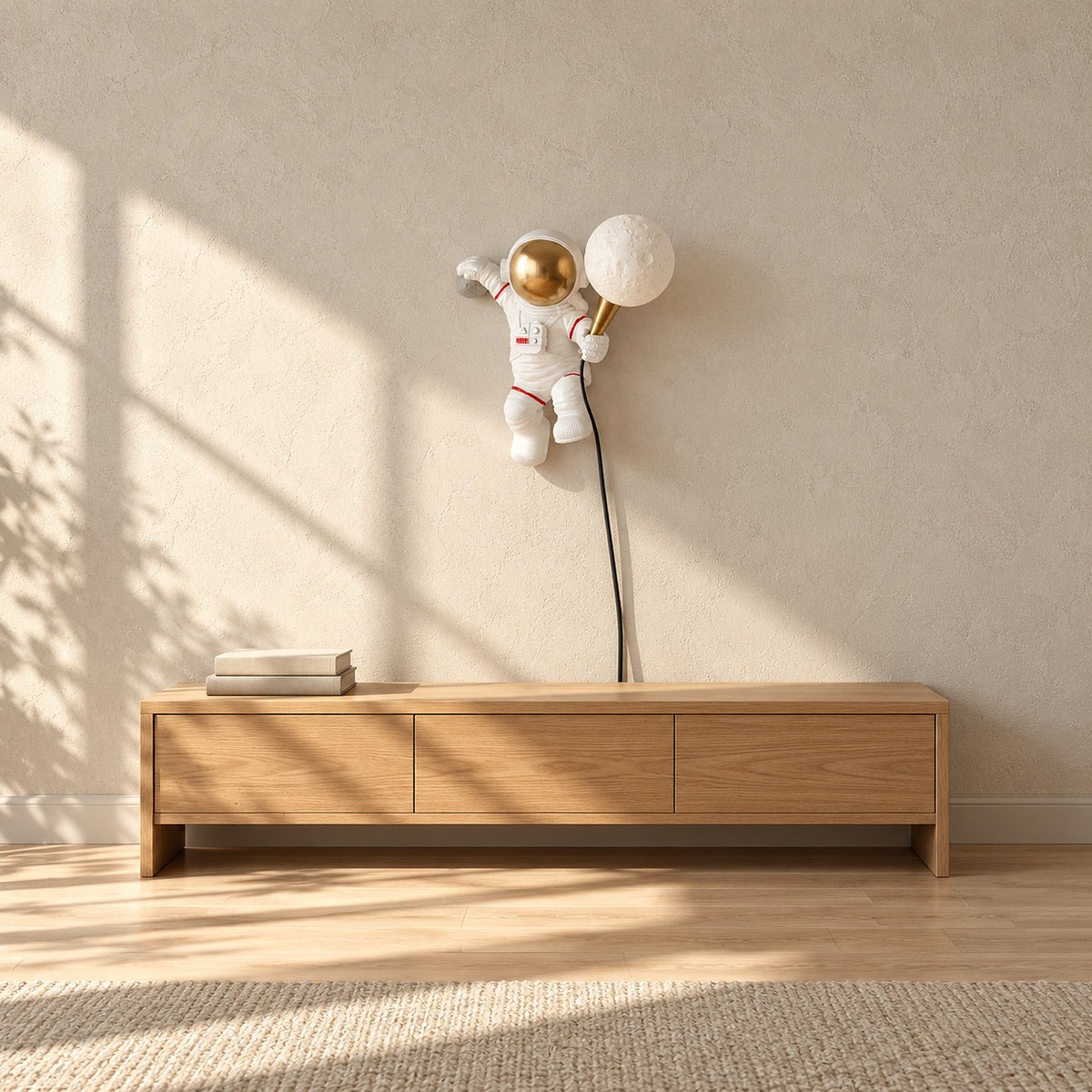 Ciremola white and gold plug in wall light, unlit astronaut with globe and black cord above a wooden sideboard