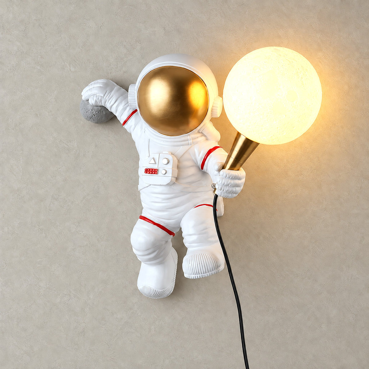 Ciremola white and gold wall light, astronaut holding up a glowing globe shade
