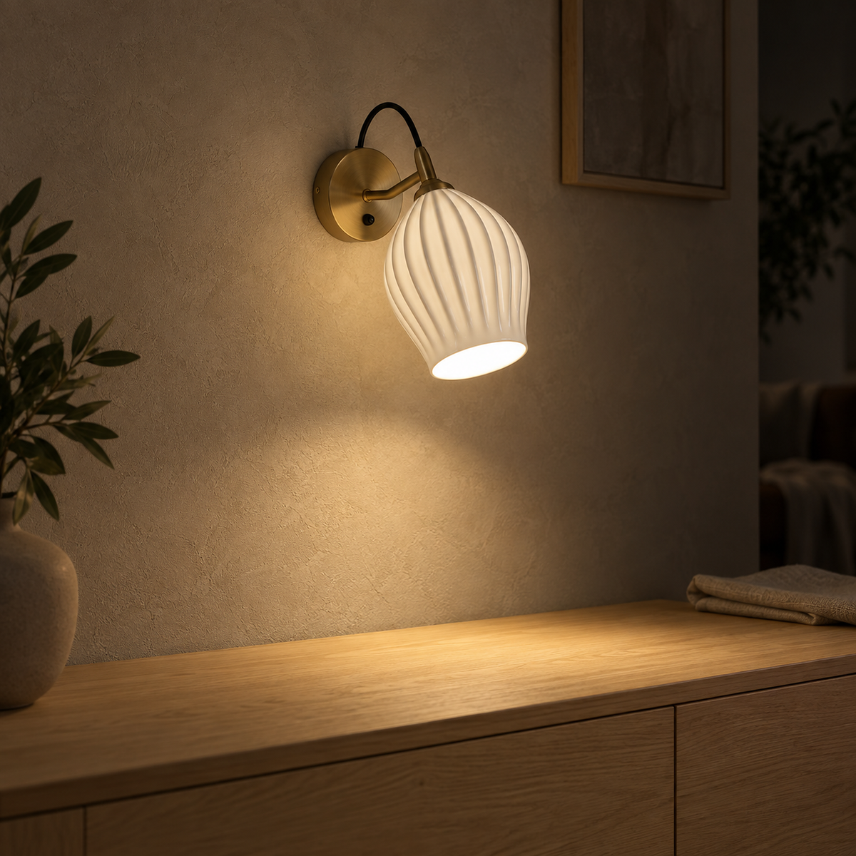 Comirel copper wall light casting a warm pool of light over a clear dining sideboard #color_copper