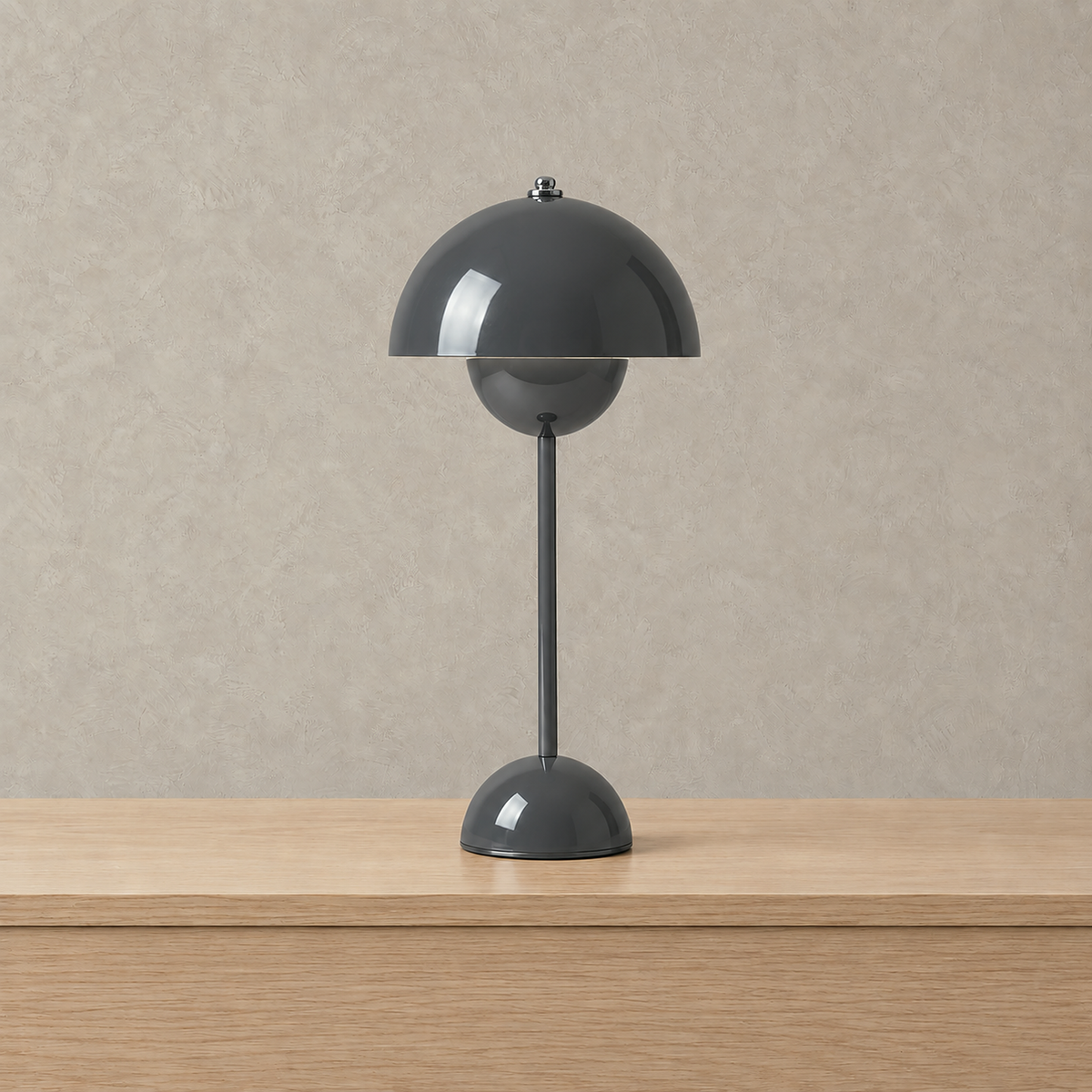 Coremila gray table lamp shown switched off on a plain backdrop #color_gray