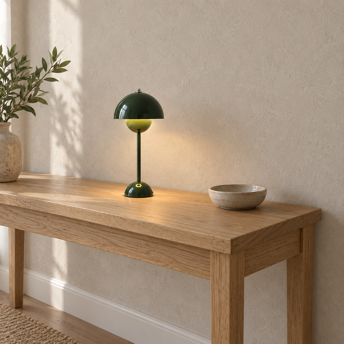 Coremila green portable table lamp showing its base with warm white light spilling below