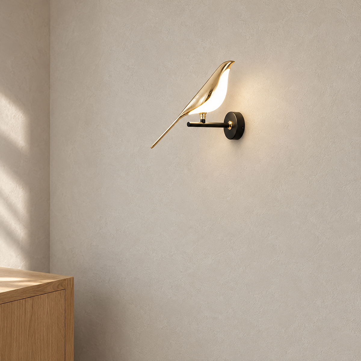 Corsavel 1 bird gold and black hardwired wall sconce lit above plain plaster in a living room