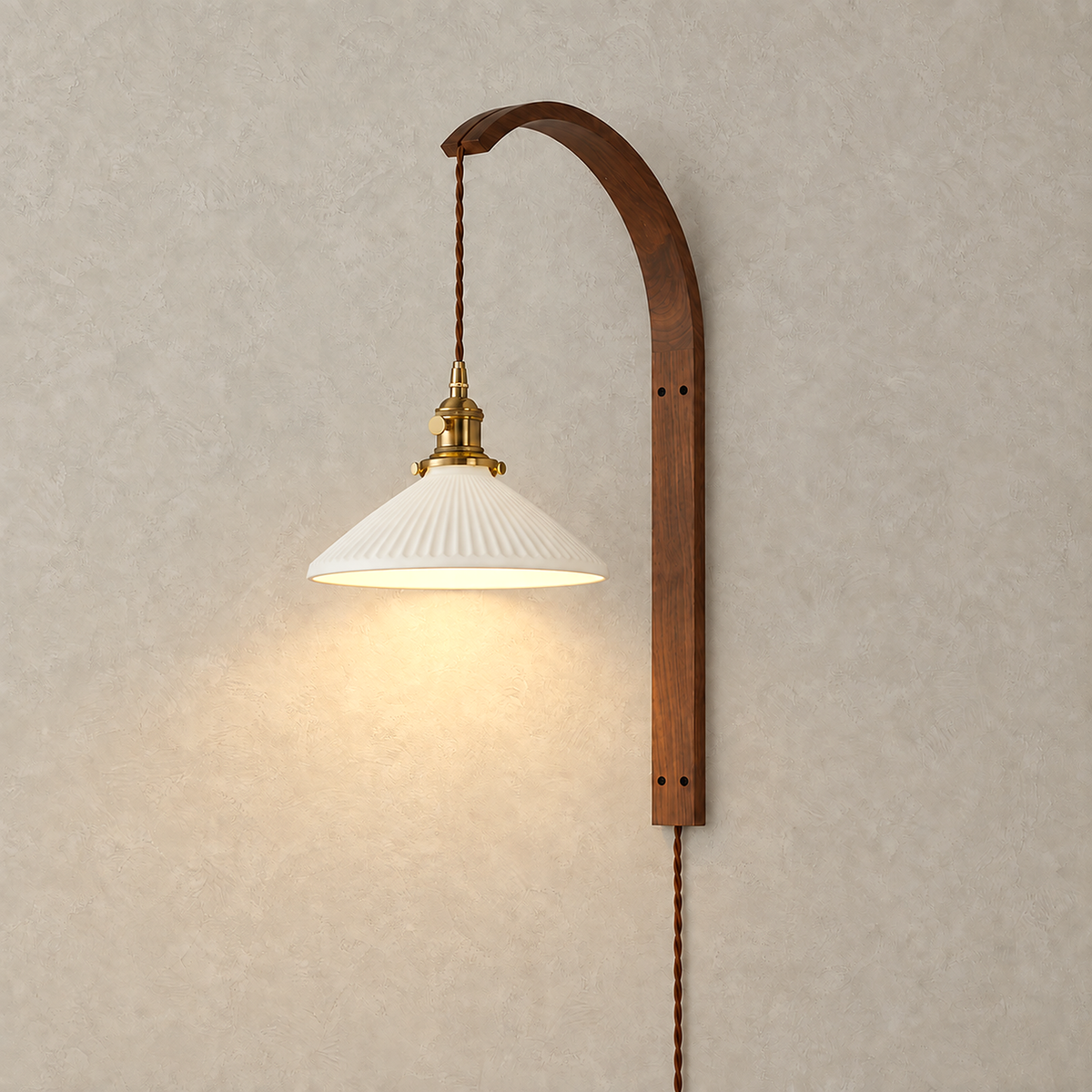 Cosineri walnut color LED wall sconce glowing beneath its white flared shade on a plain backdrop