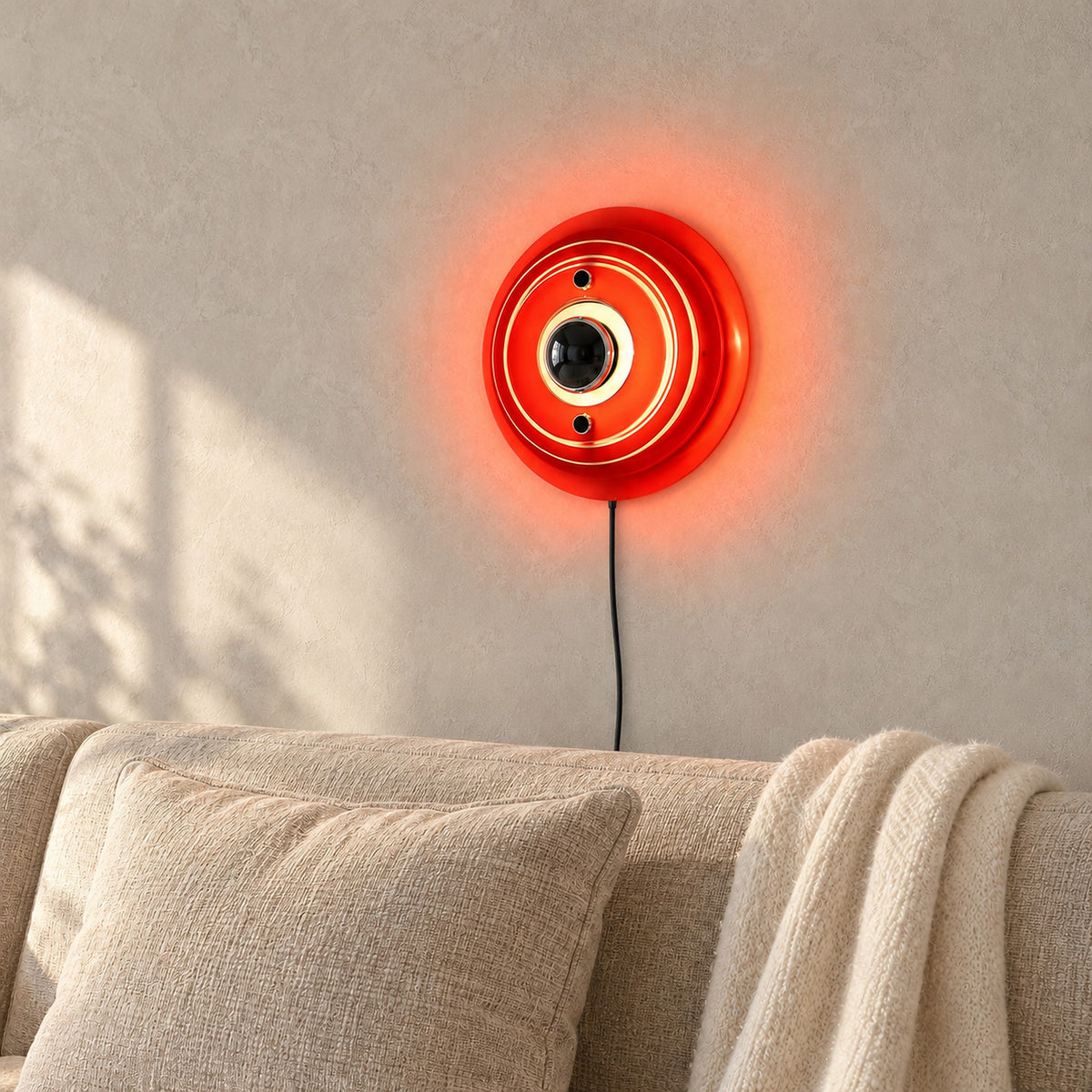 Elsarvo orange wall lamp glowing above neutral seating in a daylit snug #color_orange