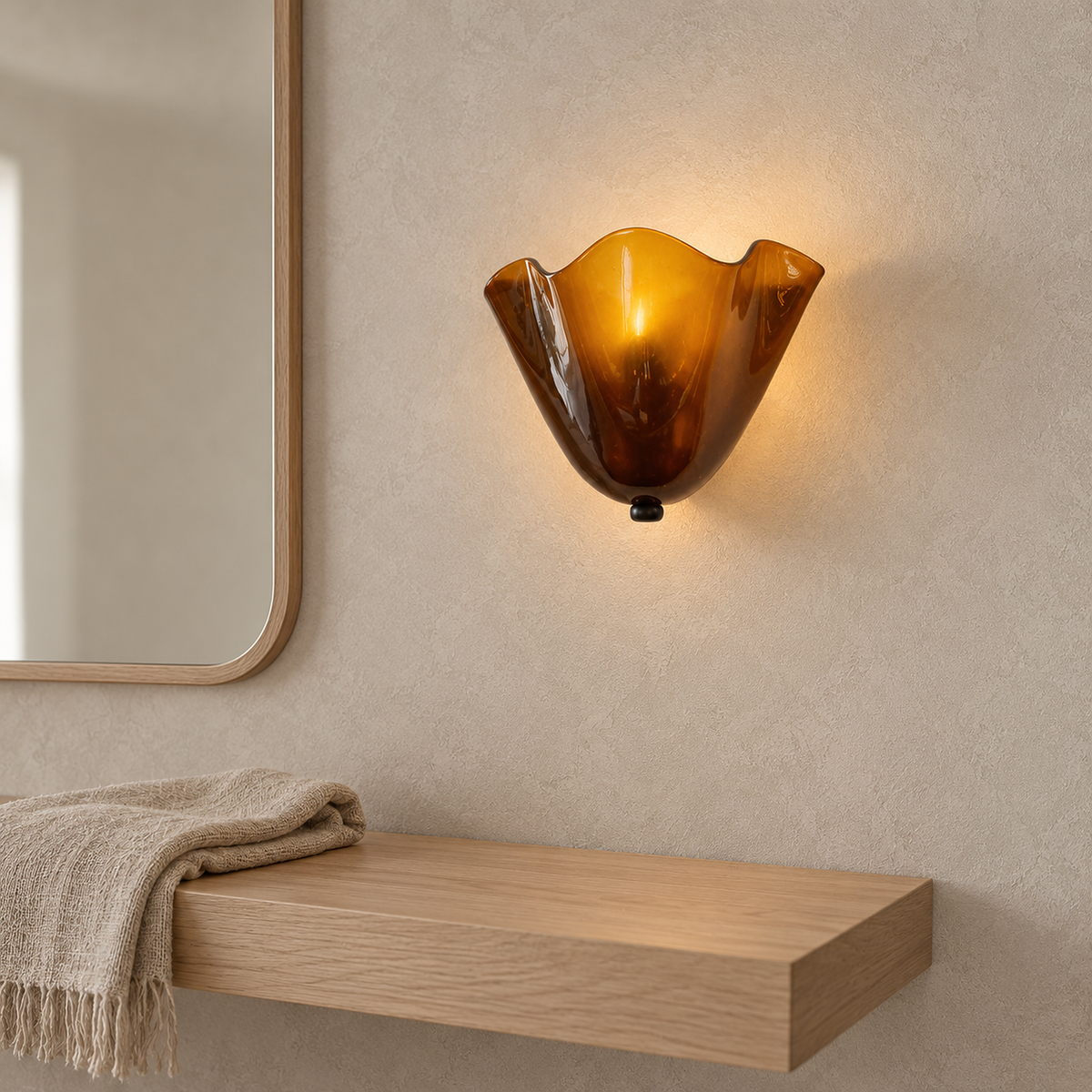 Ilsaren amber wall sconce lit beside a mirror in a bedroom dressing corner by day #color_amber