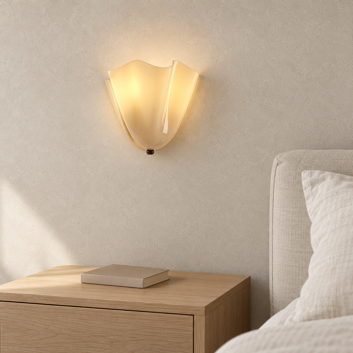 Ilsaren beige bedside wall light glowing beside ivory bedding in a daylit bedroom #color_beige