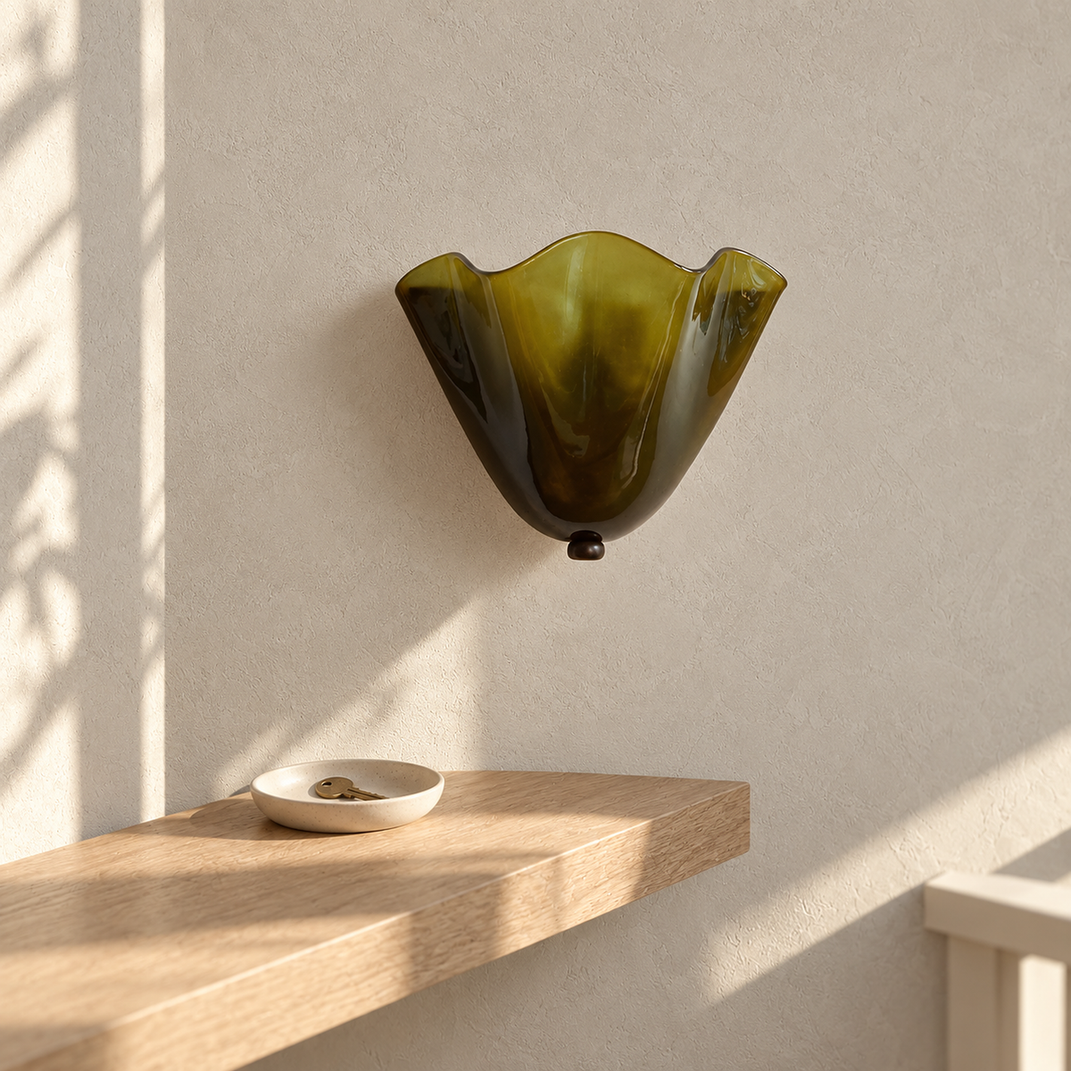 Ilsaren green plug in wall light, unlit, with its glass shade in direct daylight on a landing