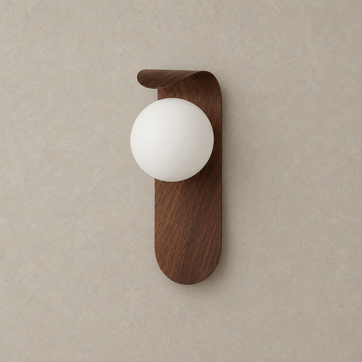 Ilvarne walnut hardwired wall sconce, unlit, with its globe shade and curved backplate on greige plaster