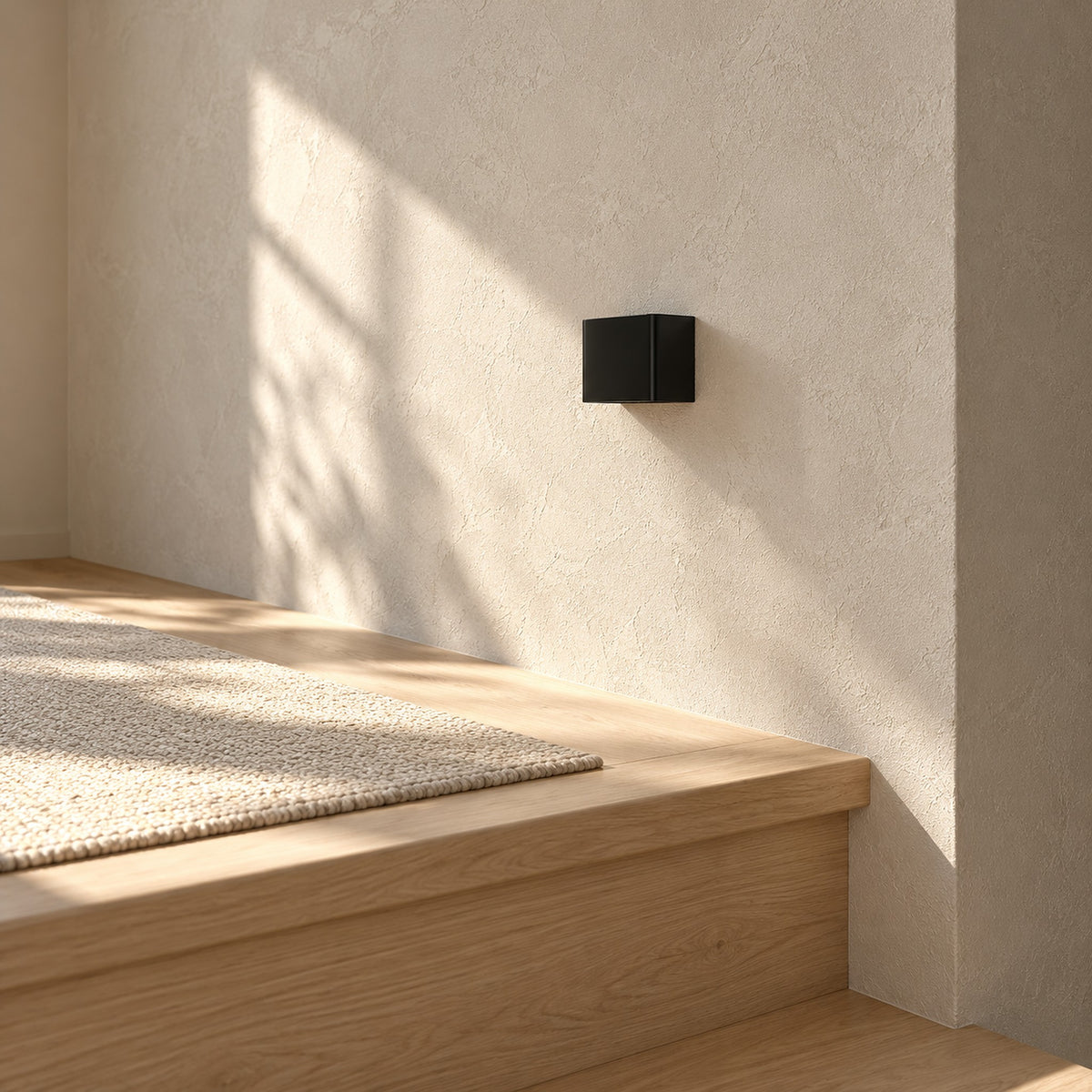 Ivelmo black battery operated wall sconce switched off on an empty upper landing by day
