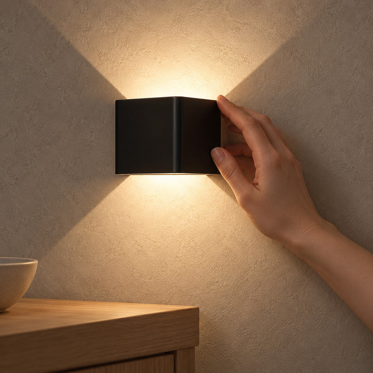 Ivelmo black LED wall sconce in a dining room, showing its compact side profile