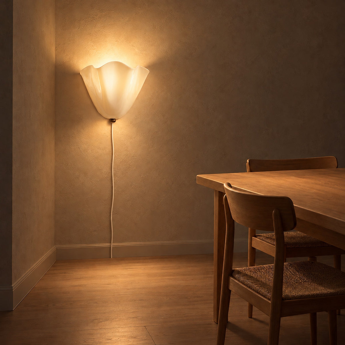 Lanorvi ivory glass wall sconce lighting a dining room corner at night with the floor below left clear