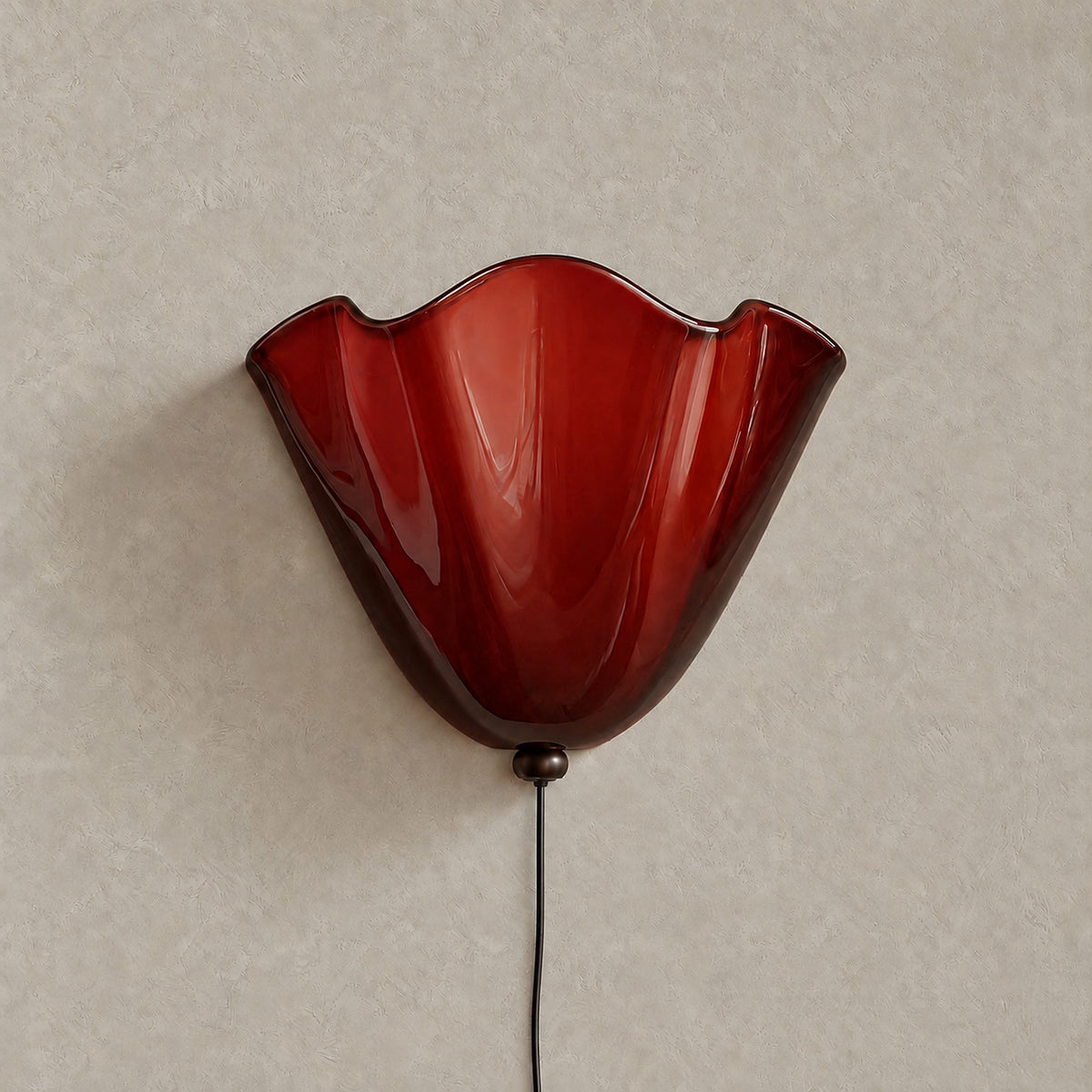Lanorvi red glass bedside wall light, unlit against warm greige plaster #color_red