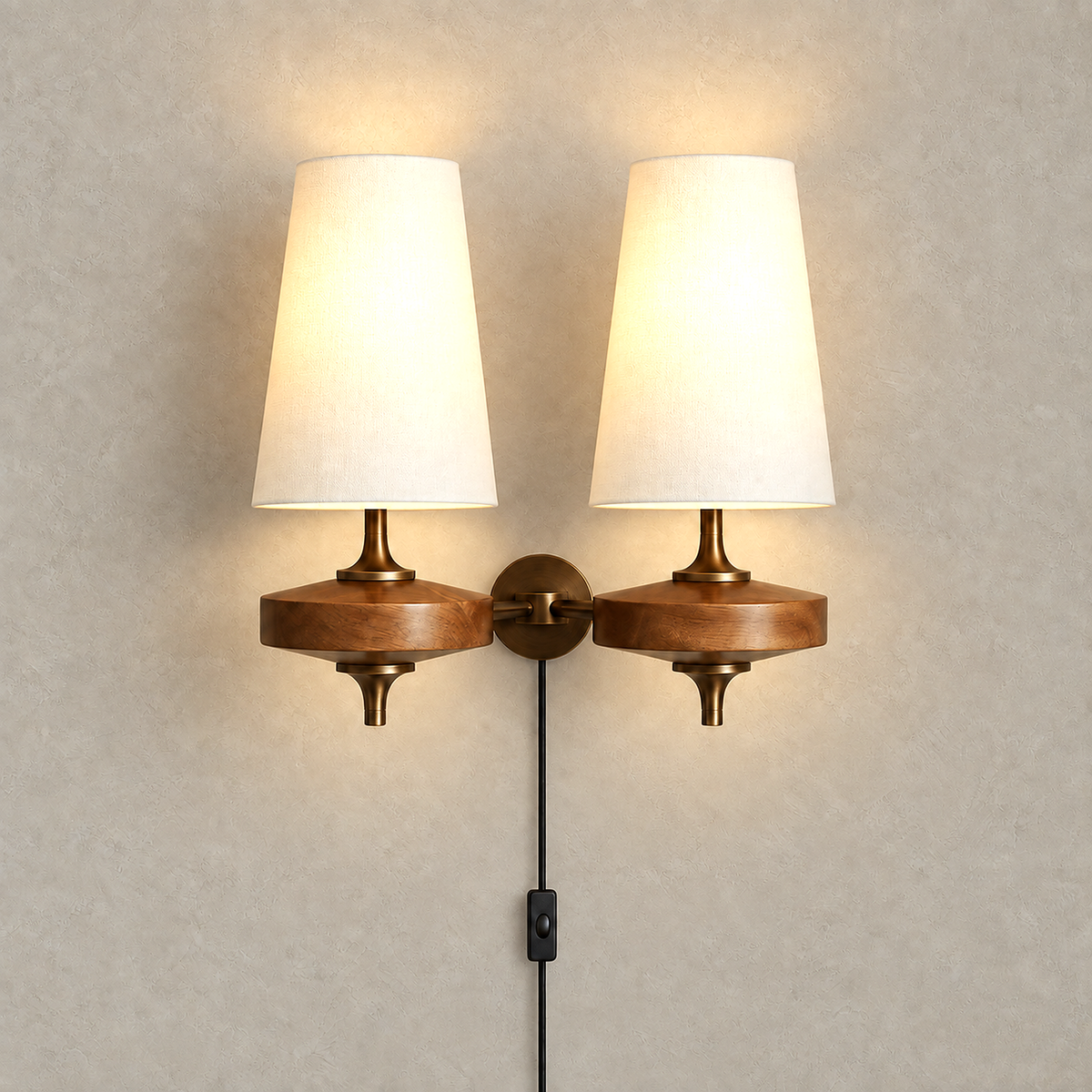 Larevio white wall sconce with both fabric shades lit on a plain plaster wall #color_white