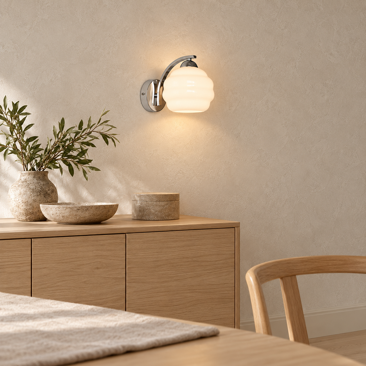 Lasemiro white wall lamp lit beside dining room furniture in daylight