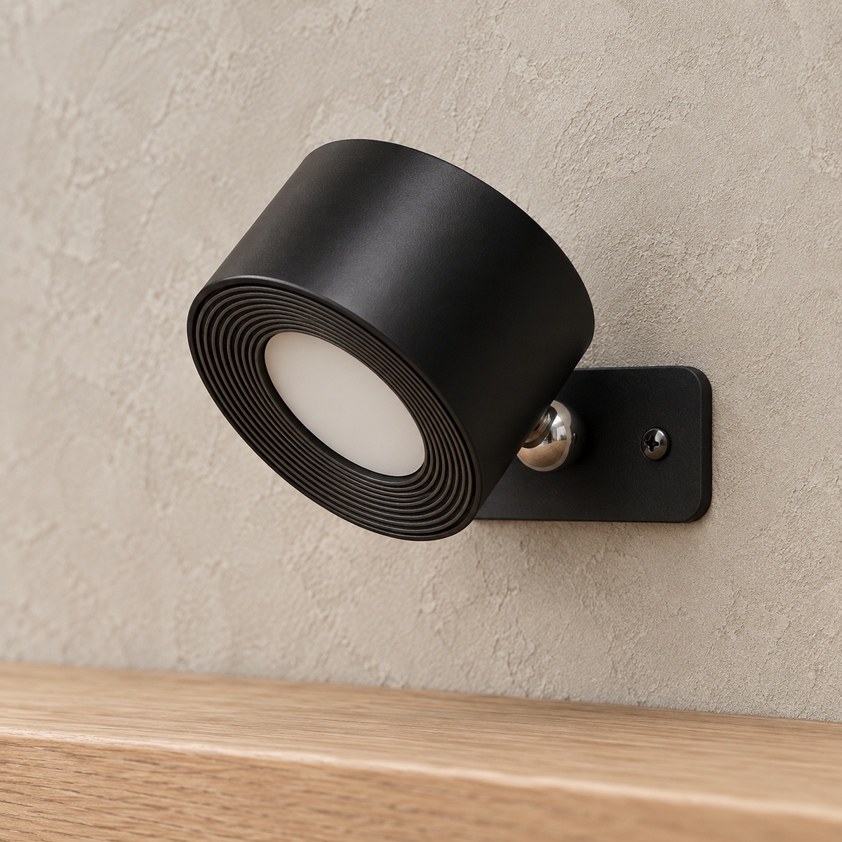 Lasirel black battery operated wall sconce close up with its unlit ridged face