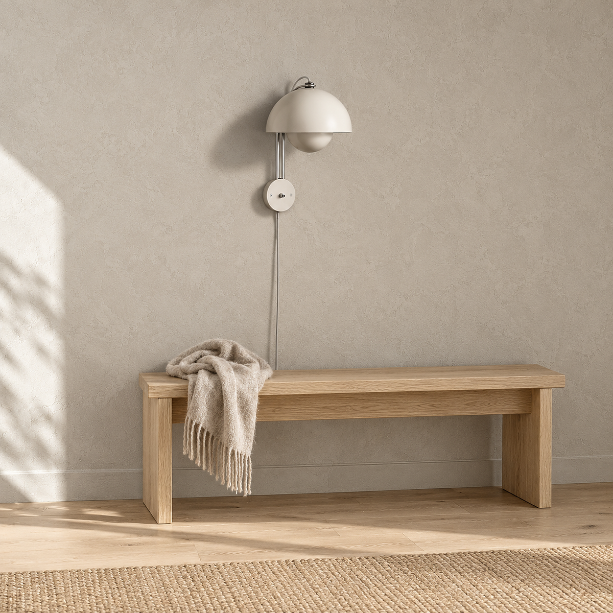 Lasorme cream plug in wall lamp unlit above a sunlit bench in an entryway
