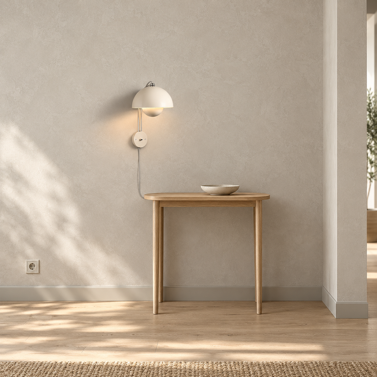 Lasorme Cream plug in wall sconce lit above a wooden console table, with its cord trailing behind the table.