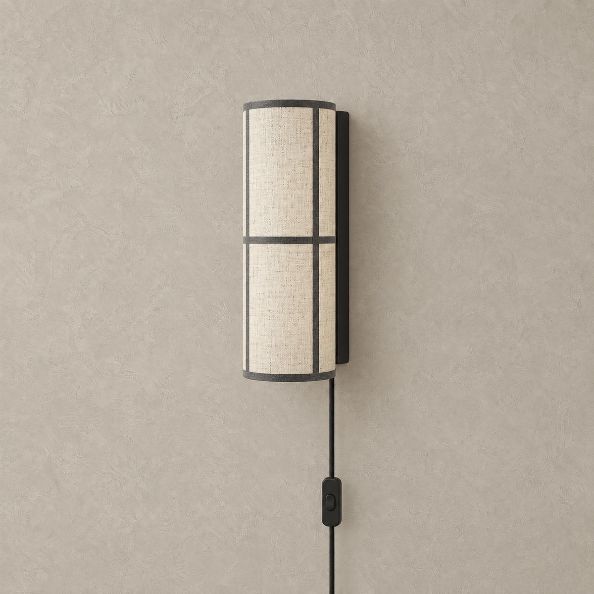 Lassivor white plug in wall sconce with unlit cylindrical shade on a dark backplate