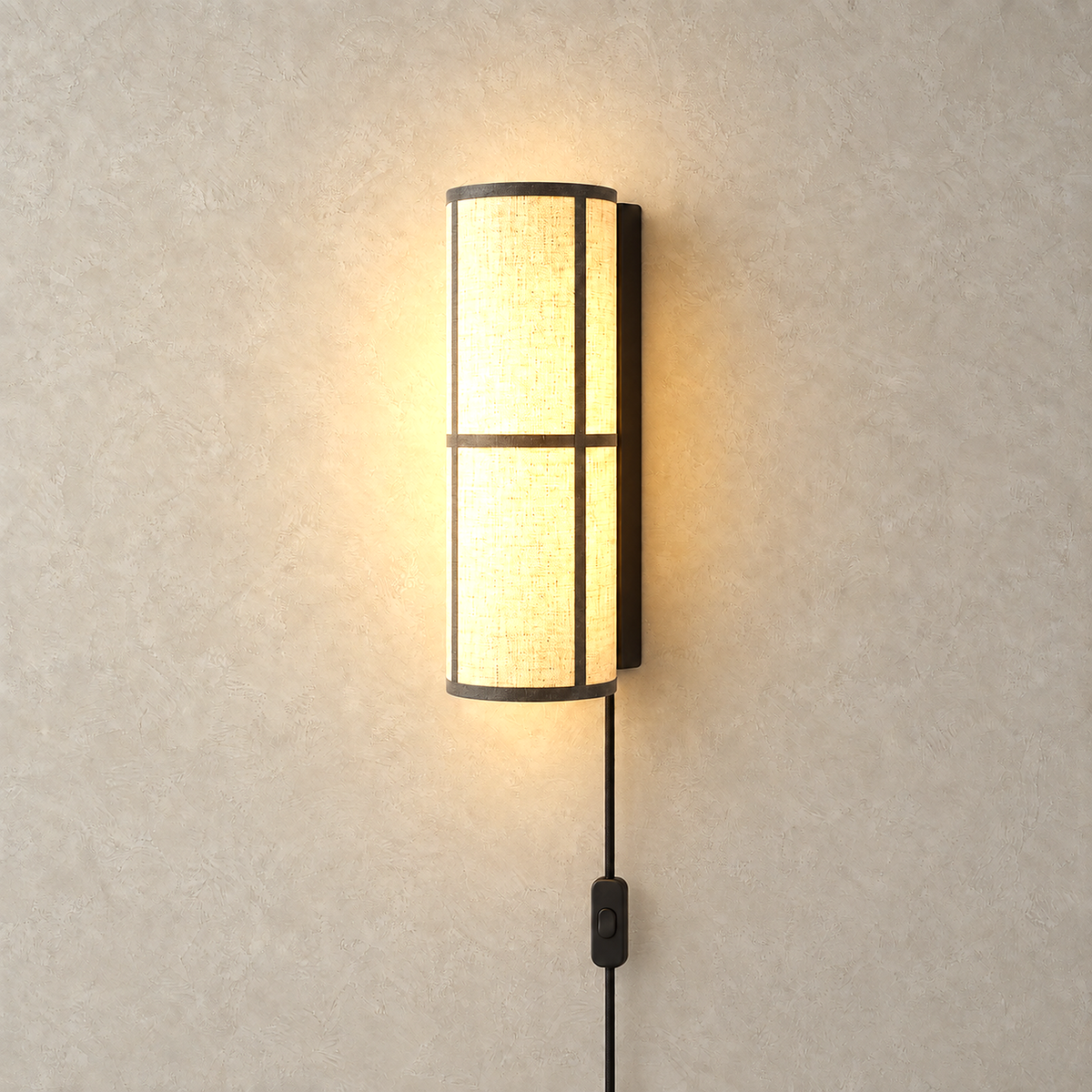 Lassivor white shaded wall light lit against warm plaster in a plain studio plate