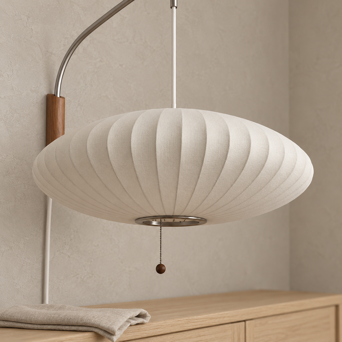 Lavomel chrome and walnut tone wall light, close view of the unlit fabric shade ribs and underside opening