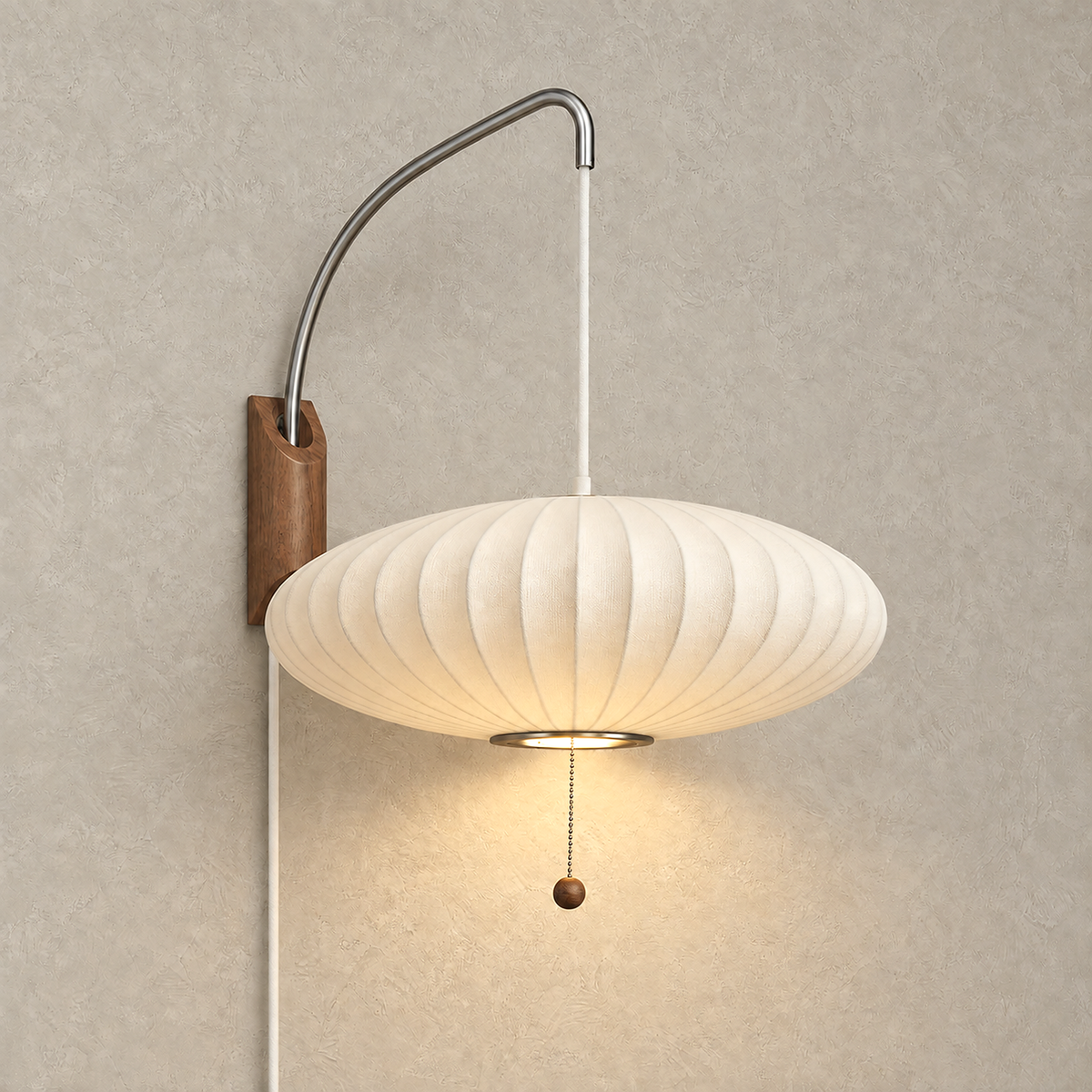 Lavomel chrome and walnut tone wall sconce lit against warm plaster, its ribbed fabric shade glowing
