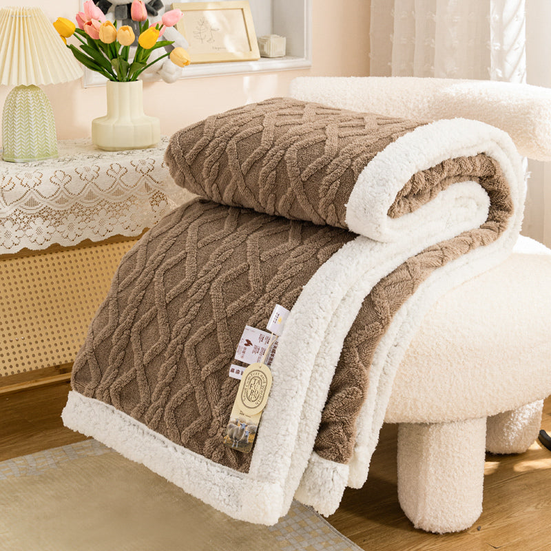 Lerivosa reversible fleece throw blanket draped over a white chair, showing brown textured fleece and white plush lining.