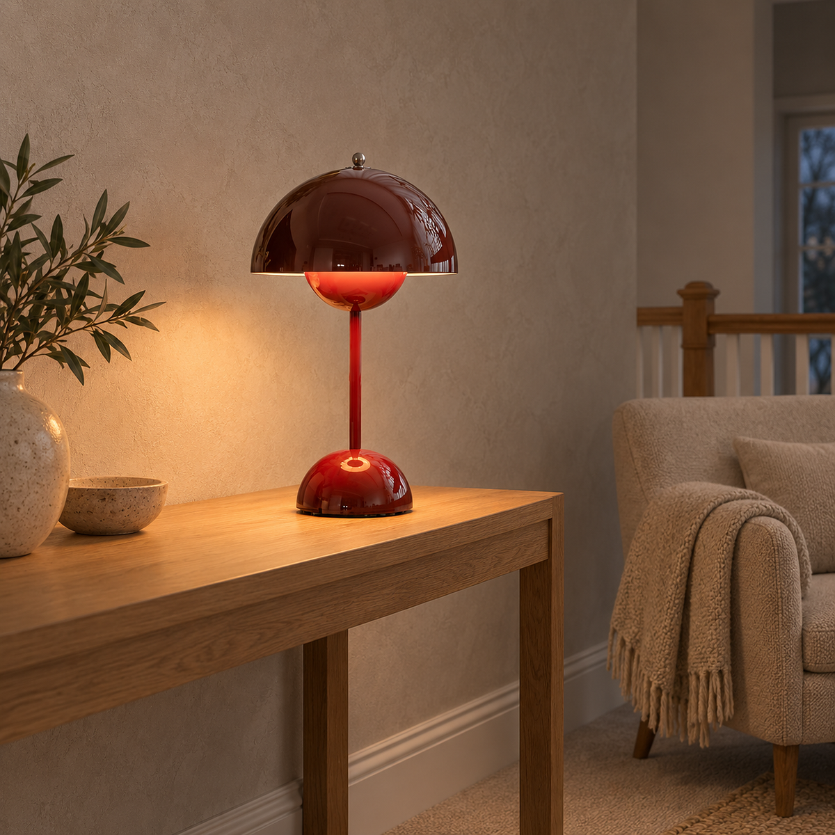 Linoveta red claret cordless table lamp glowing beside an armchair on an upstairs sitting landing