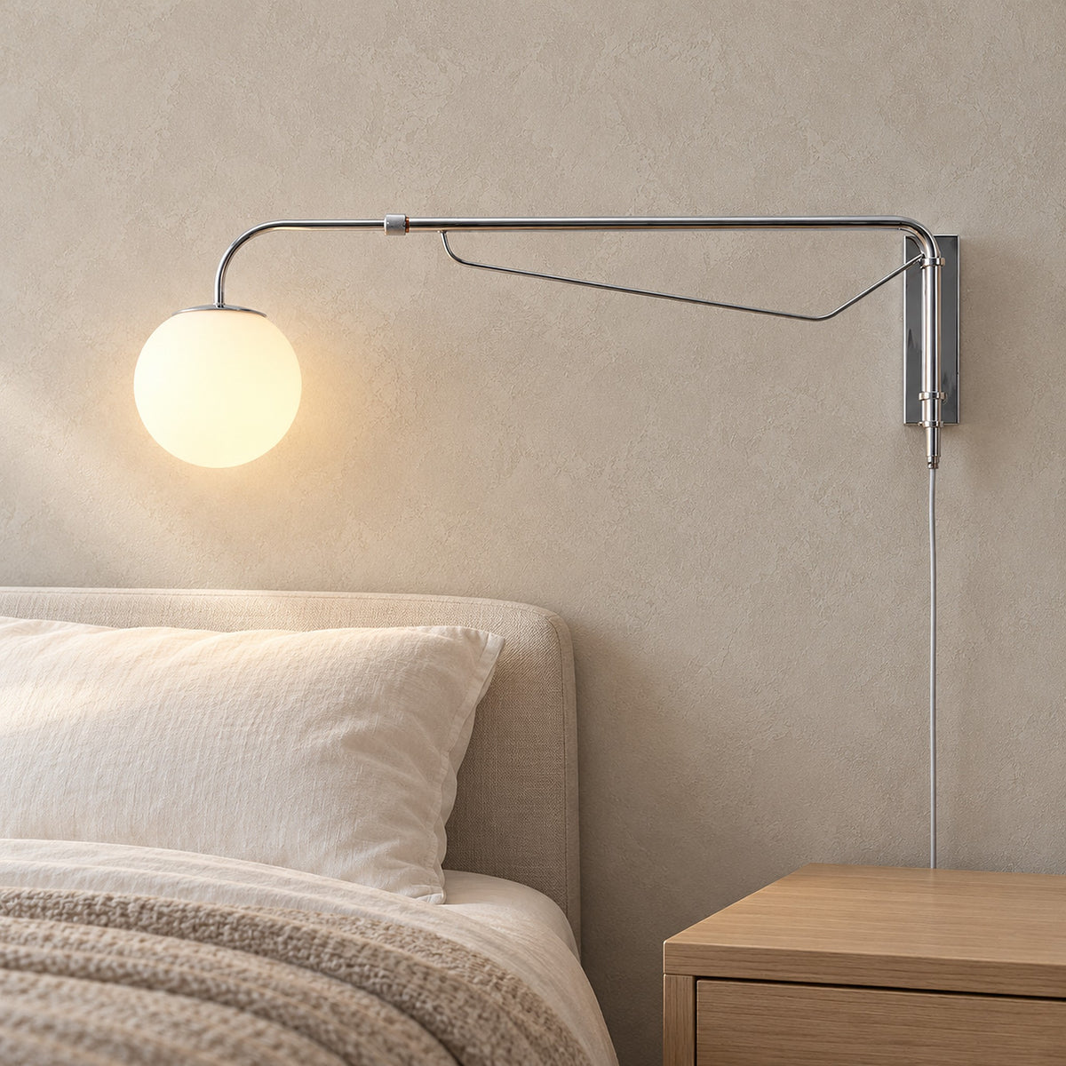 Lirelso chrome and white bedside wall light glowing above a clear nightstand in a guest sleeping alcove