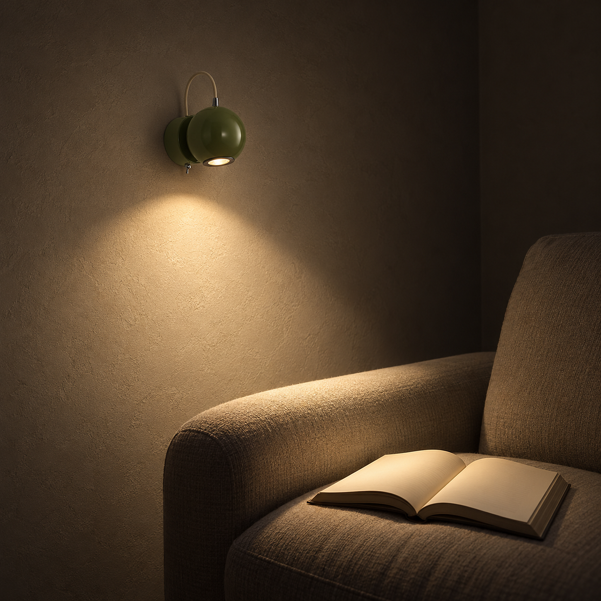 Lirema green adjustable wall lamp lighting a book beside a living room armchair at night