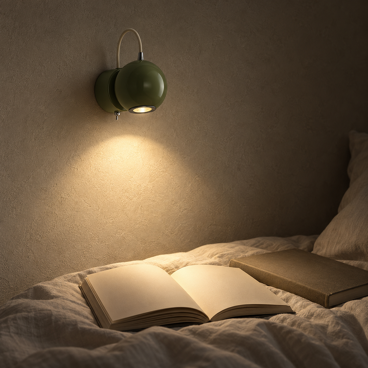 Lirema green wall lamp lighting a bedtime book in a dim sleeping alcove at night