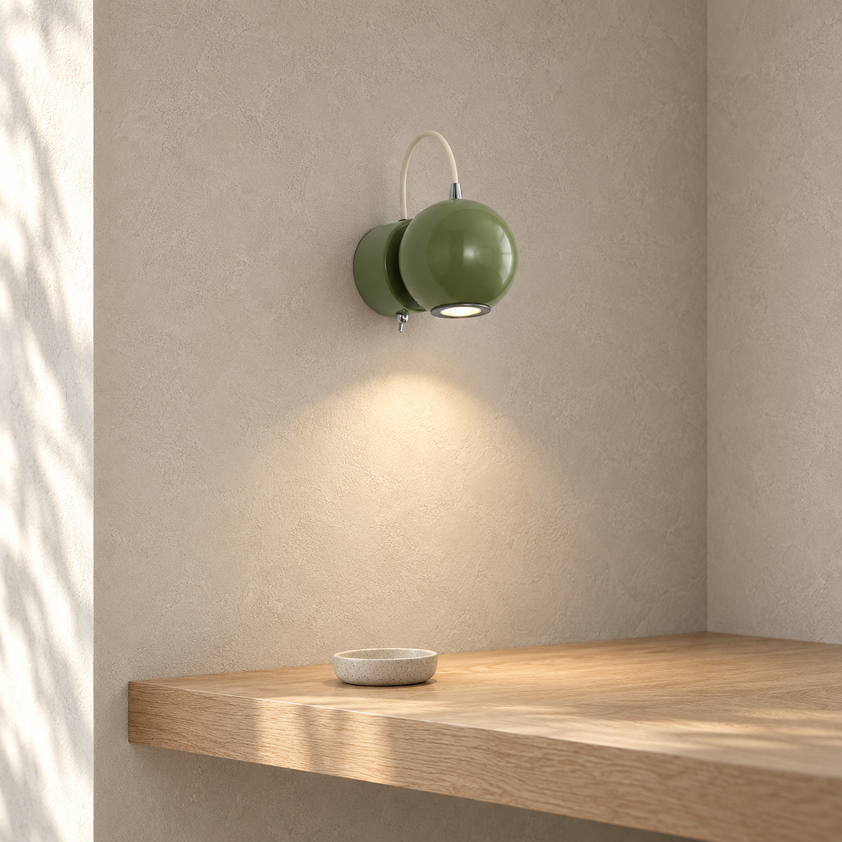 Lirema green wall light glowing in a dressing nook, showing its matching green wall base
