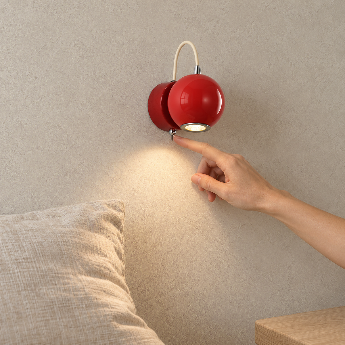 Lirema red wall lamp mounted above a clear bedside tabletop in a sleeping alcove by day #color_red